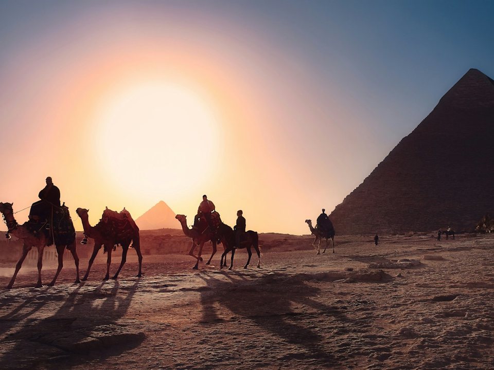 Camel caravan near the pyramids at sunset, a top attraction